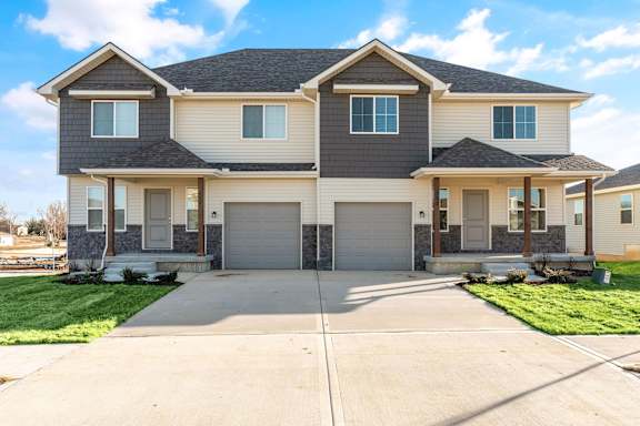 a house with two garage doors and a driveway