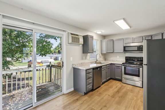 A kitchen with a refrigerator, microwave, and oven. at Ridgeview Apartments, Fortville, IN, 46060