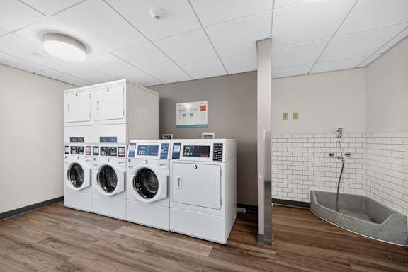 A row of washing machines in a laundromat.