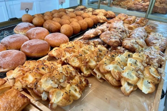 a display case filled with different types of pastries and doughnuts