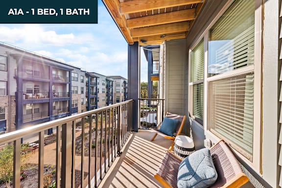 A balcony with a chair and a pillow on it.