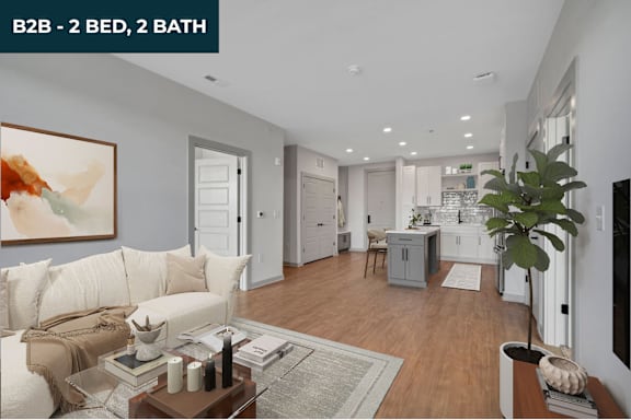 A spacious living room with a sofa, a coffee table, and a large painting on the wall.