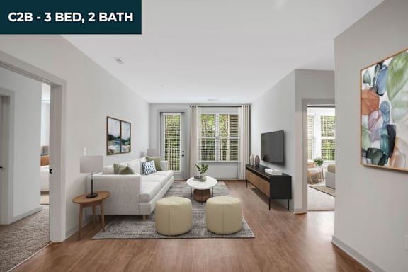 A spacious living room with a sofa set, a coffee table, and a television.