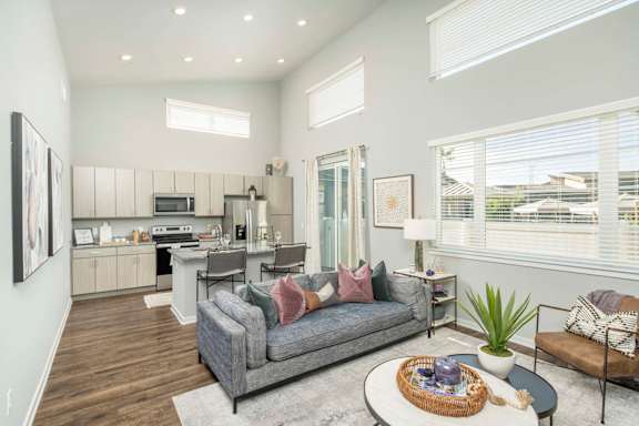 A modern living room with a grey sofa and a coffee table. at Grandstone at Sunrise, Peoria, AZ, 85383