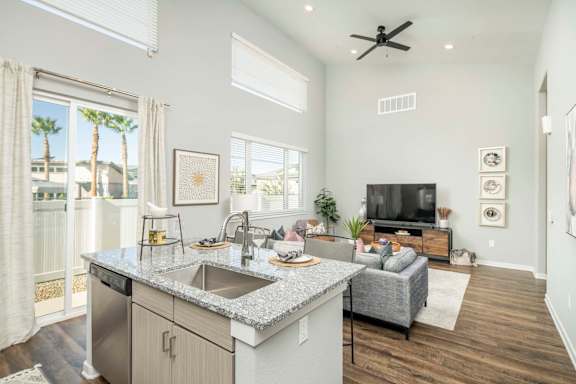 a kitchen and living room with a sink and a tv at Grandstone at Sunrise, Peoria, AZ, 85383