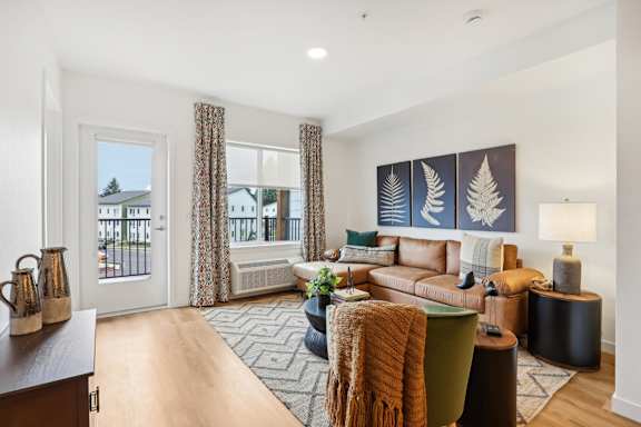 a living room with a couch and a door to a balcony