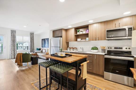 an open kitchen and living room with a table and chairs