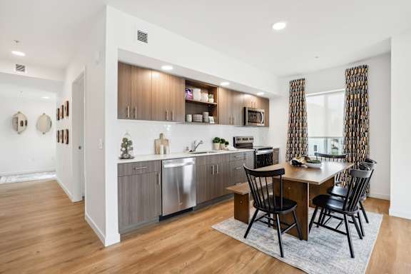 a kitchen and dining room with a table and chairs