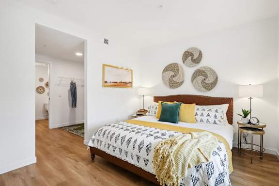 a bedroom with a bed and a painting on the wall