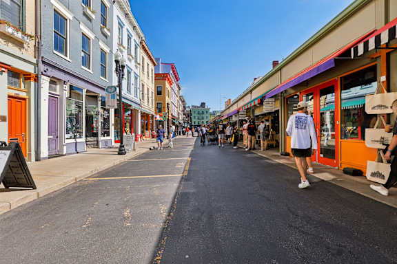 A street scene with a person walking down the middle of the road.