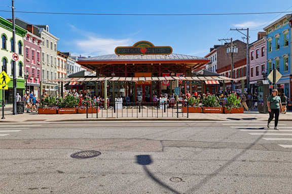 A street view with a crosswalk and a building with a red awning.