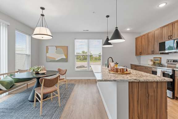 A modern kitchen with a dining table and chairs.