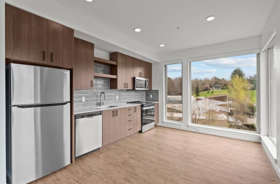 a kitchen with stainless steel appliances and a large window
