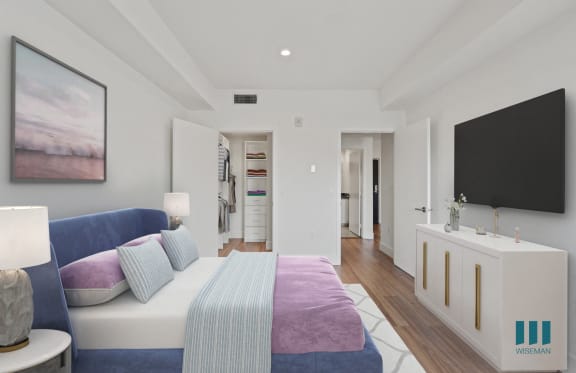 a bedroom with a bed and two blue stools
