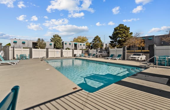 a swimming pool with a metal fence around it