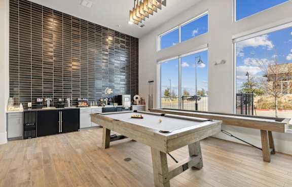 A pool table in a room with a kitchen in the background, Ironcrest, TX, 76180