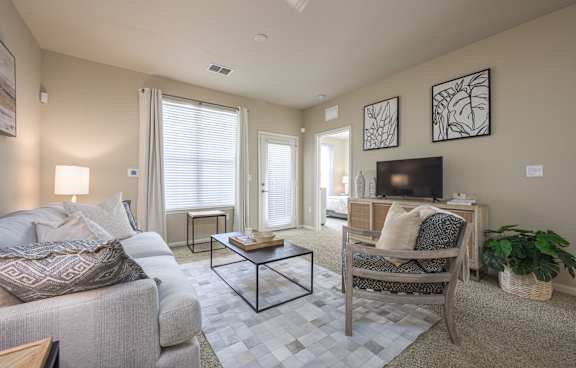 a clubhouse with couches and chairs and a television at Spring Creek Apartments, Crestview, FL 32536