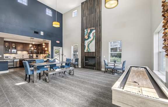 a clubhouse with a pool table and a bar and a kitchen