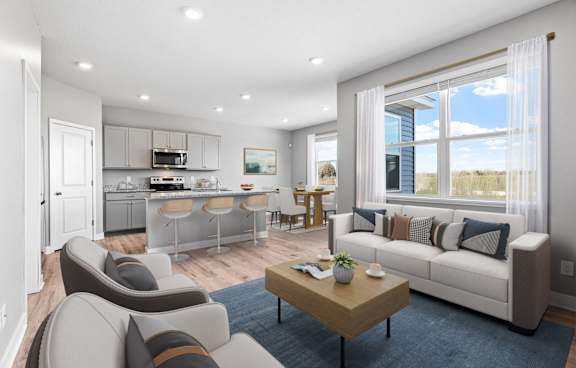a living room and kitchen with a couch and a table
