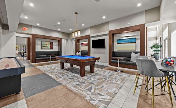 a game room with a pool table and a shuffleboard