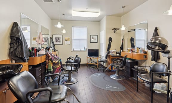 a salon room with chairs and mirrors