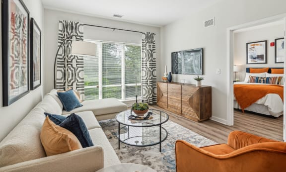 a living room with a couch and a table   and a bed