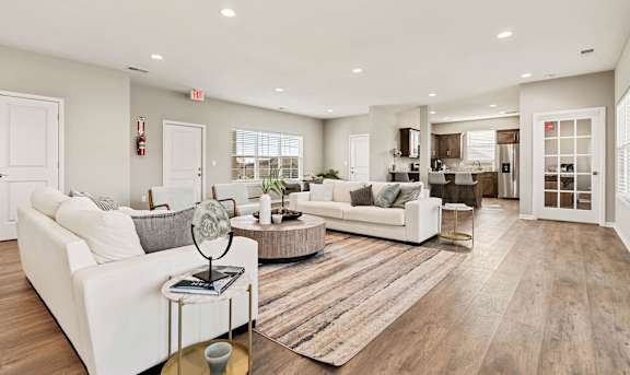 A modern kitchen with stainless steel appliances and wooden floors.