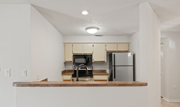 a kitchen with a counter top and a refrigerator