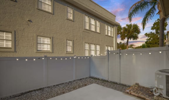 a white privacy fence in front of a house