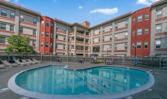 a swimming pool in front of an apartment building