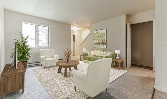 a living room with white furniture and a rug