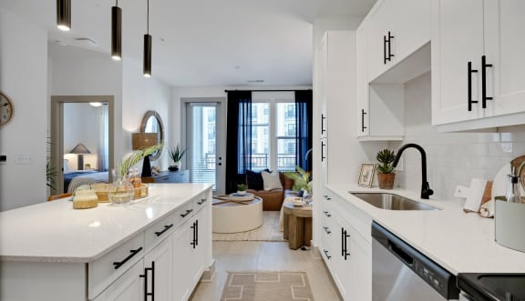 a rendering of a kitchen and living room with a view of a balcony at Metropolitan at the Riverwalk, North Carolina