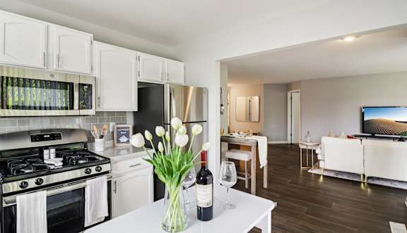 Modern kitchen with stainless steel appliances and white cabinetry at Ashford at Geneva Apartments in Geneva, IL – pet-friendly homes in the Far Northwest Chicago Suburbs