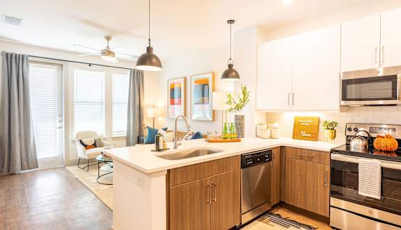 A modern kitchen with wooden cabinets and stainless steel appliances.