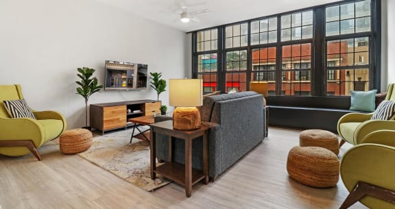 a living room with a couch and chairs and a large window