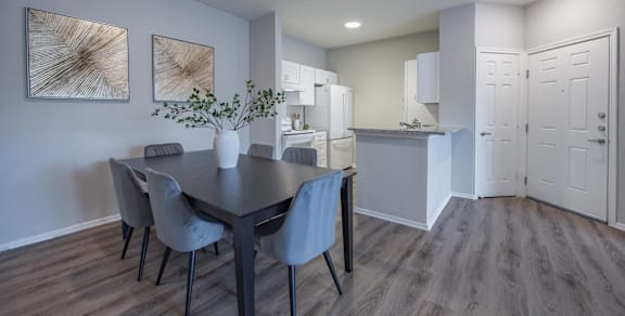 A white kitchen with a refrigerator, oven, and cabinets.
