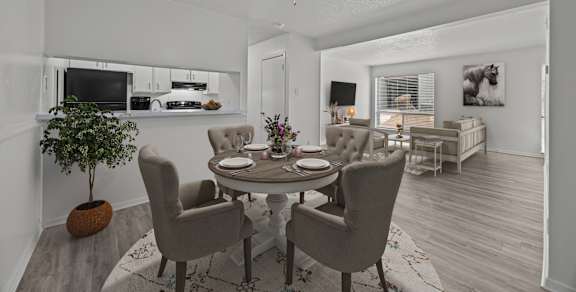 A dining room with a round table and chairs.