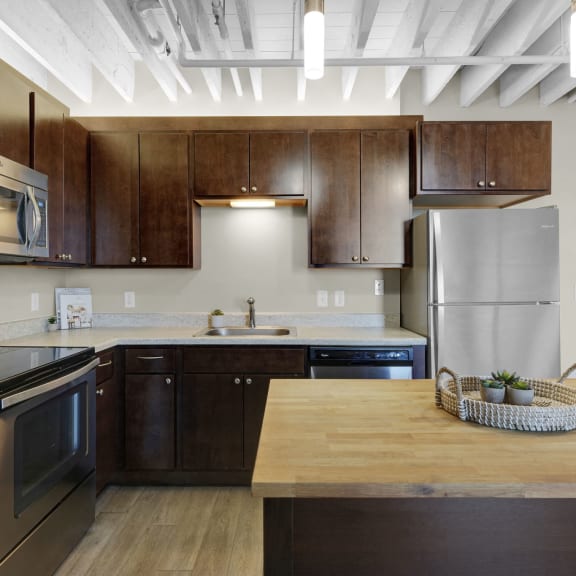 a kitchen with stainless steel appliances and wooden cabinets