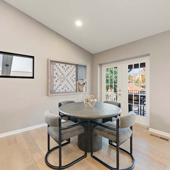 a dining room with a table and chairs
