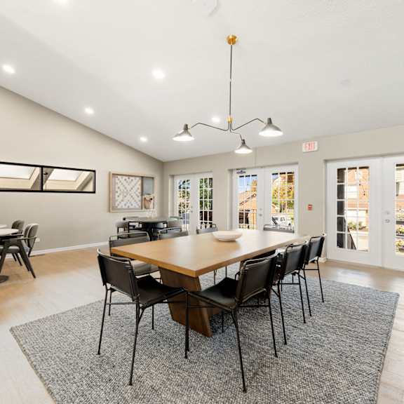 a patio with tables and chairs and a fire pit