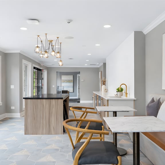 A modern kitchen with a dining table and chairs.