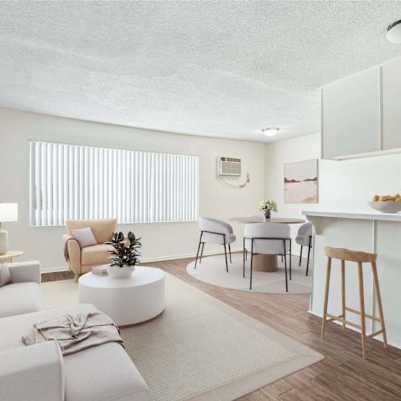 A well-lit, modern living room with a kitchen area in the background.