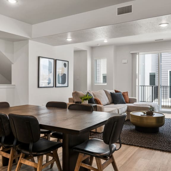 a living room with a dining room table and chairs