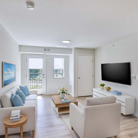 A bedroom with a large bed and a flat screen TV.