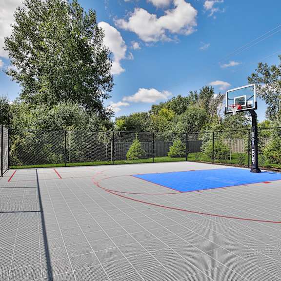 A basketball court with a blue surface and a red outline.