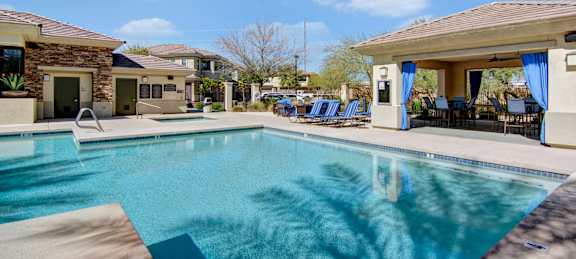 A swimming pool in a sunny backyard.