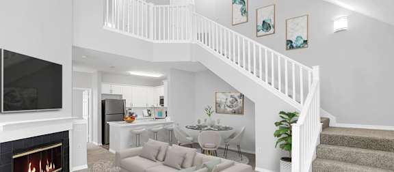 a living room with a staircase in the background and a couch in the foreground at Northlake Park Apartments, Florida, 32827