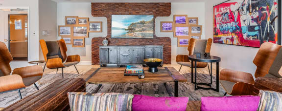 a living room with a fireplace and a bunch of pictures on the wall