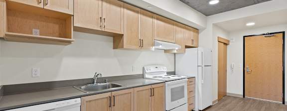 A kitchen with wooden cabinets and white appliances.