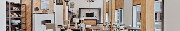 A modern dining room with wooden floors and furniture.